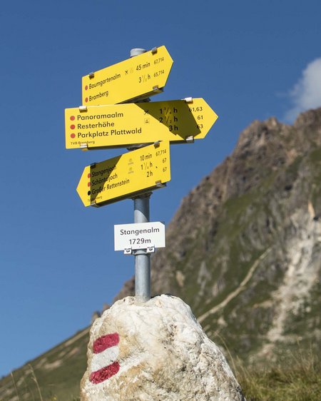 Smaragdhotel Tauernblick – your 4-star hotel near Wildkogel Trail signpost at 1729m with mountain in background under blue sky