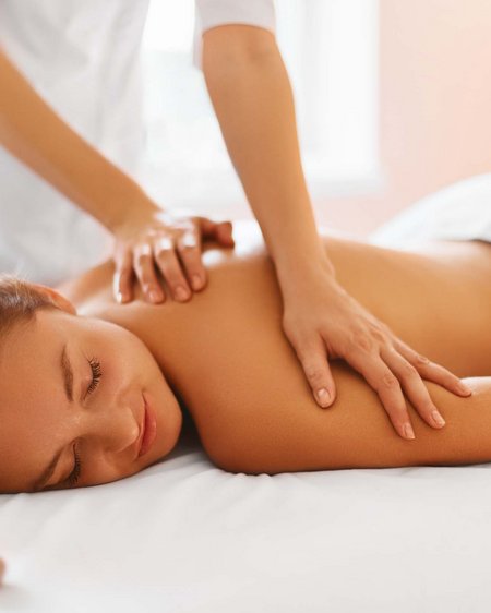 Your couples’ holiday in Austria Woman receiving relaxing back massage on massage table