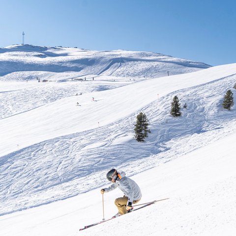 Hohe Tauern National Park: holiday for bikers Skier on snowy slope with clear blue sky