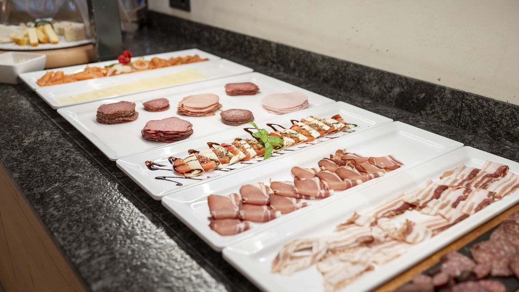 Salzburgerland: wellness hotel with 4 stars and cuisine Various sliced meats and cheeses on white plates on a counter
