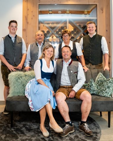 Wildkogel: a hotel with an eye for the extraordinary Family group in traditional attire sitting in modern living room